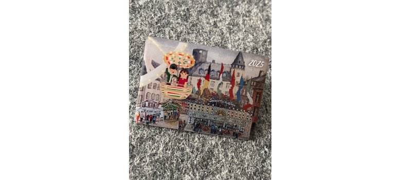 Foto eines rechteckigen Ansteck-Pins mit Motiv der Genovevaburg zum Lukasmarkt, traditionelles Souvenir des Volksfest