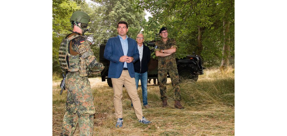 Oberbürgermeister Dirk Meid, Kommandeur Oberst Dr. Ferdi Akaltin und Staatssekretär Thomas Hitschler im Gespräch mit SoldatInnen des ZOpKomBw 