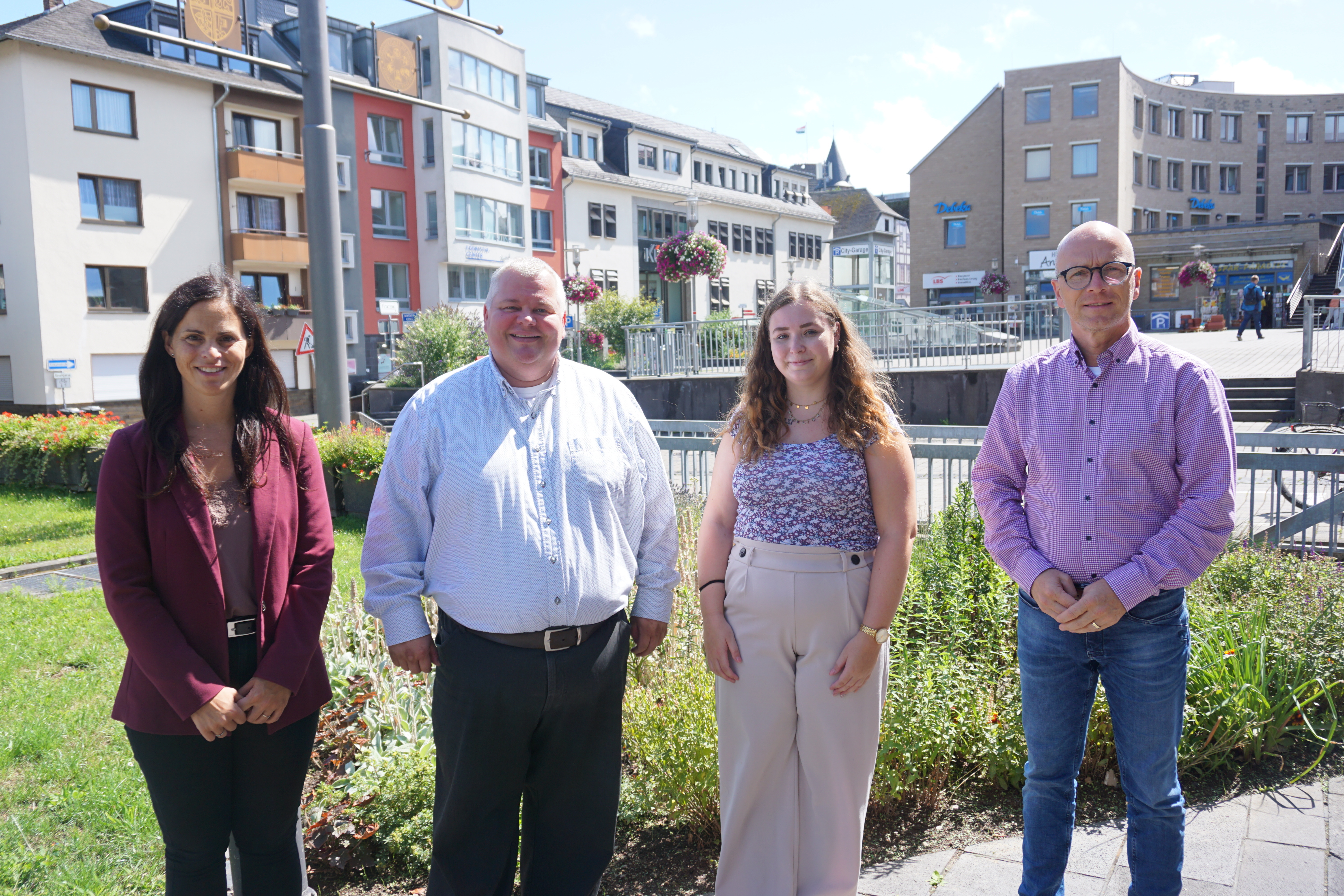 4 Personen stehend vor dem Rathaus 