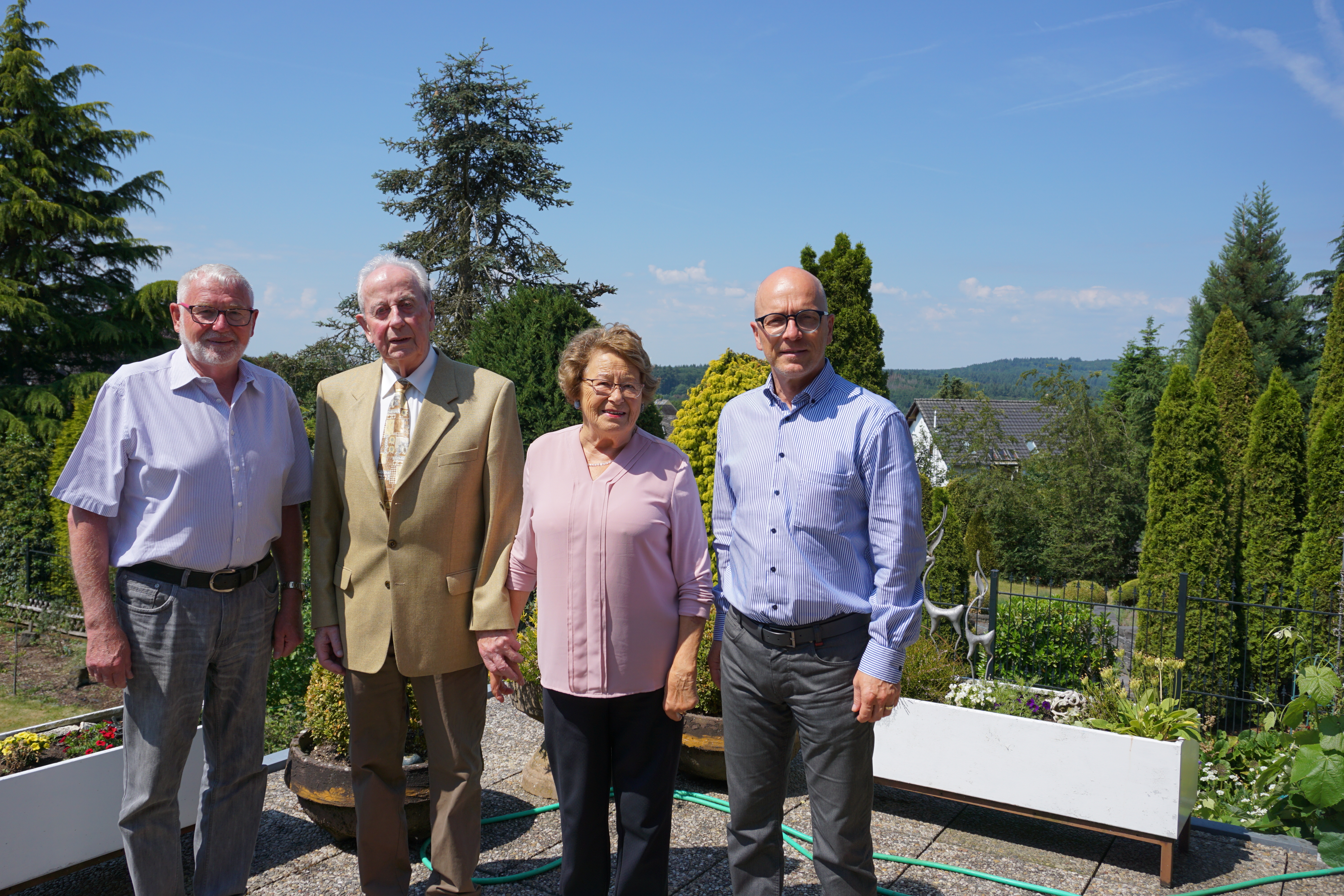 4 Personen stehen auf dem Balkon für ein Bild zusammen