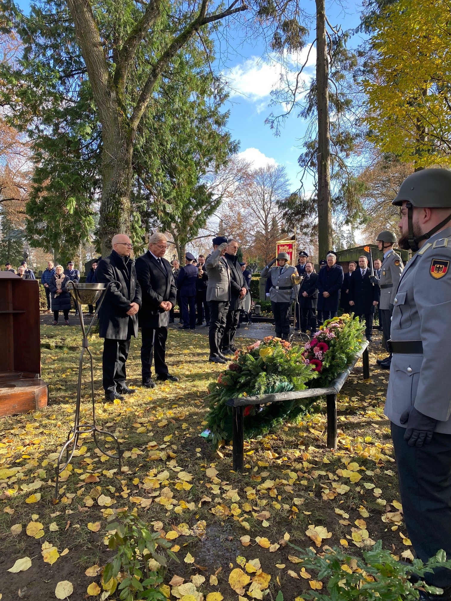 Mehrere Personen bei der Kranzniederlegung zum Volkstrauertag auf dem Mayener Hauptfriedhof