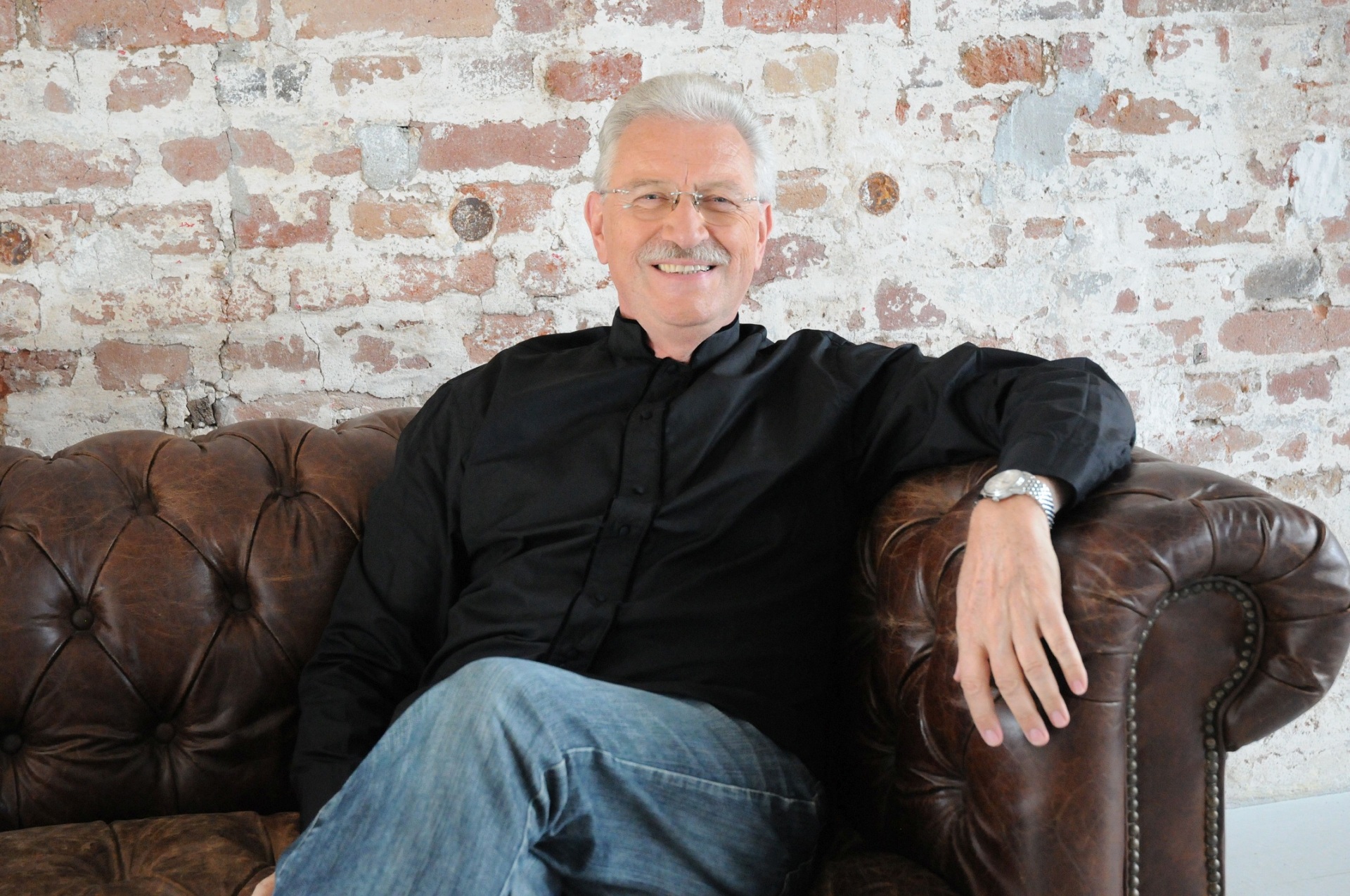 Mann sitzt auf einem Sofa