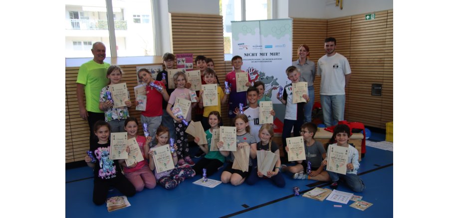 Viele Kinder posieren gemeinsam mit ihren Urkunden.