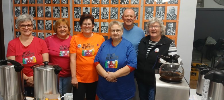 Die Organisatorinnen der Initiative „Sei ein Mensch“ beim Austausch in der Schützenhalle 6 Frauen beim Verkaufsstand