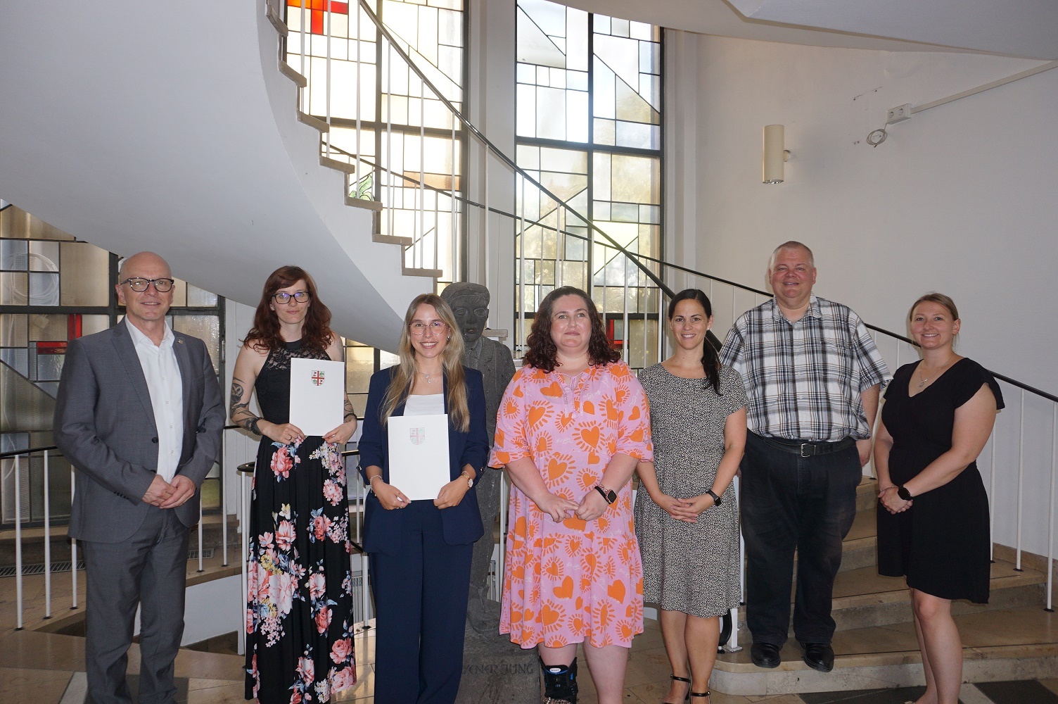 Oberbürgermeister Dirk Meid, Jana Kohnz, Carolin Stephani, Angelina Badak, Büroleiterin Jasmin Alter, Personalratsvorsitzender Wolfgang Goeken und Gleichstellungsbeauftragte Janine Pitzen stehen gemeinsam im Vorraum der Stadtverwaltung