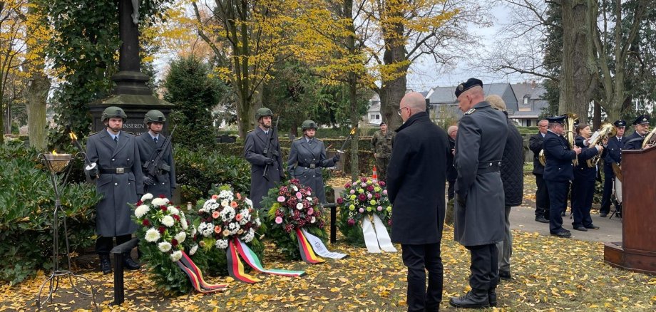 Mit einer Feierstunde wird am 15. November am Hochkreuz auf dem städtischen Friedhof in Mayen den Toten gedacht Gedenkstunde vor dem Hochkreuz mit mehreren Personen