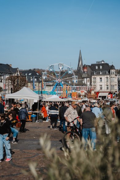 Start in den Frühling auf dem Marktplatz mit kleinem Riesenrad, Verkaufsständen und Bescuhern
